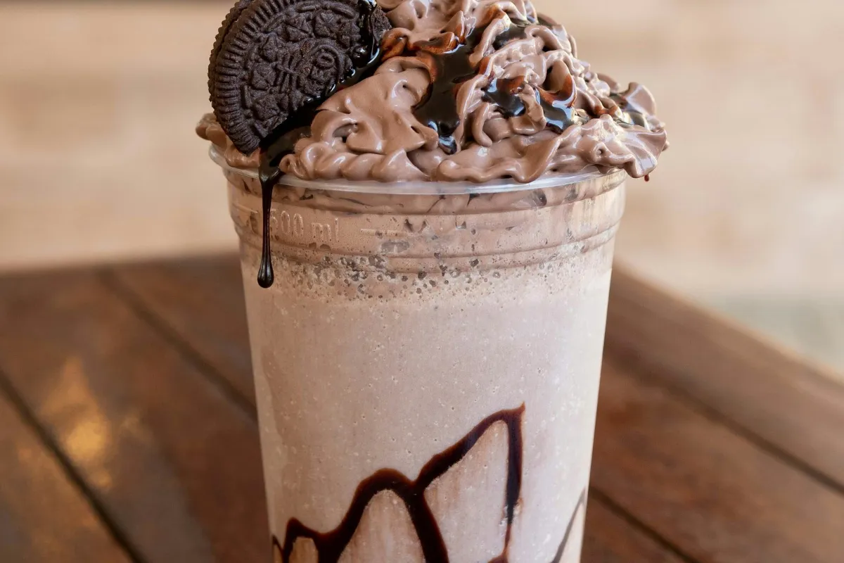 Thick milkshake with whipped cream and sprinkles, like a 7 Brew Birthday Cake Shake