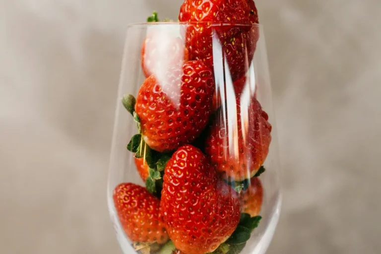 Red berry drink with ice and strawberries, like a 7 Brew Brewberry energy