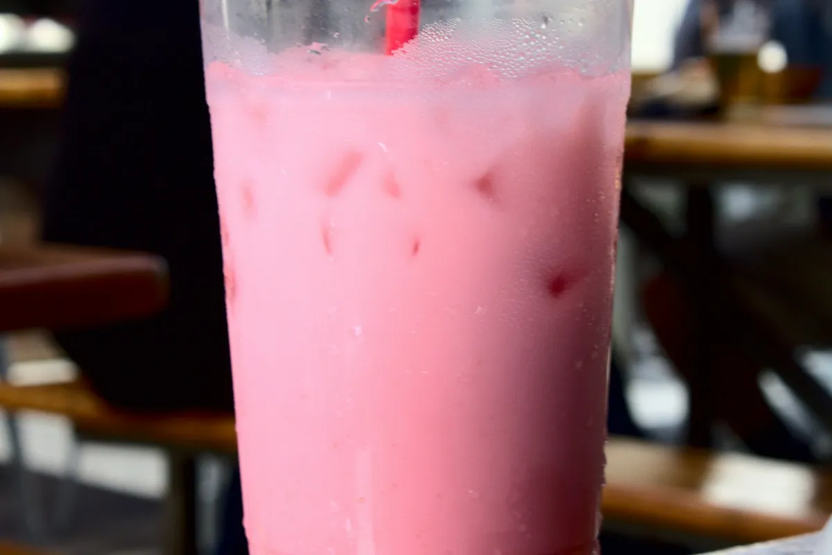 Pink strawberry lemonade with ice, like a 7 Brew Fruit Roll-Up Lemonade