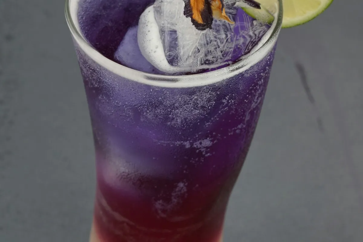 Purple layered drink with ice, like a 7 Brew Nightshade energy