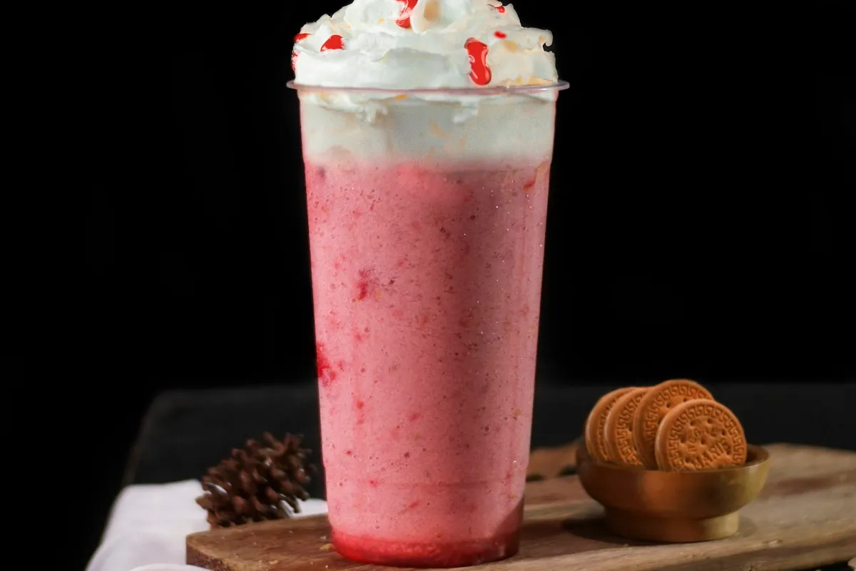 Pink and orange creamy milkshake, like a 7 Brew Orange Sherbet Shake