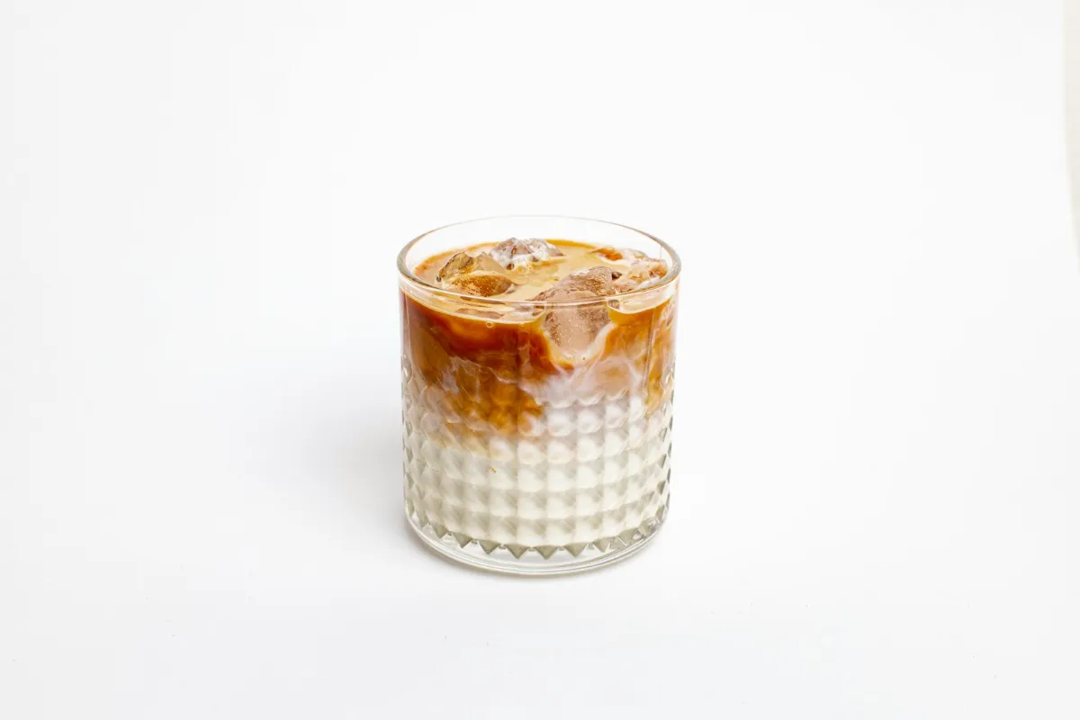 Iced latte in a glass, compared at 7 Brew and Starbucks